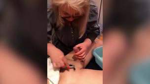Woman Trimming and Shaving Male Client